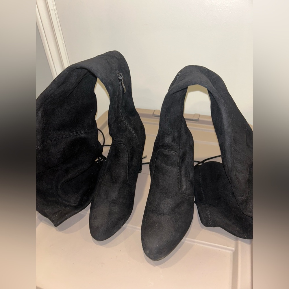 Knee high black heeled boots